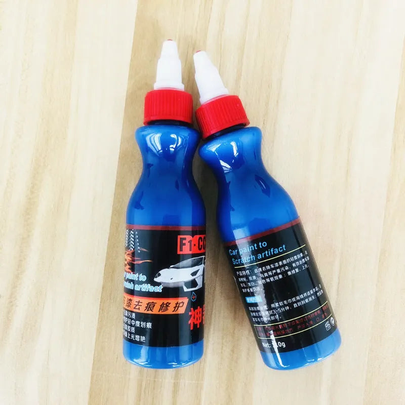 Small blue automotive scratch repair agent bottle with wiping tool for car paint scratch removal