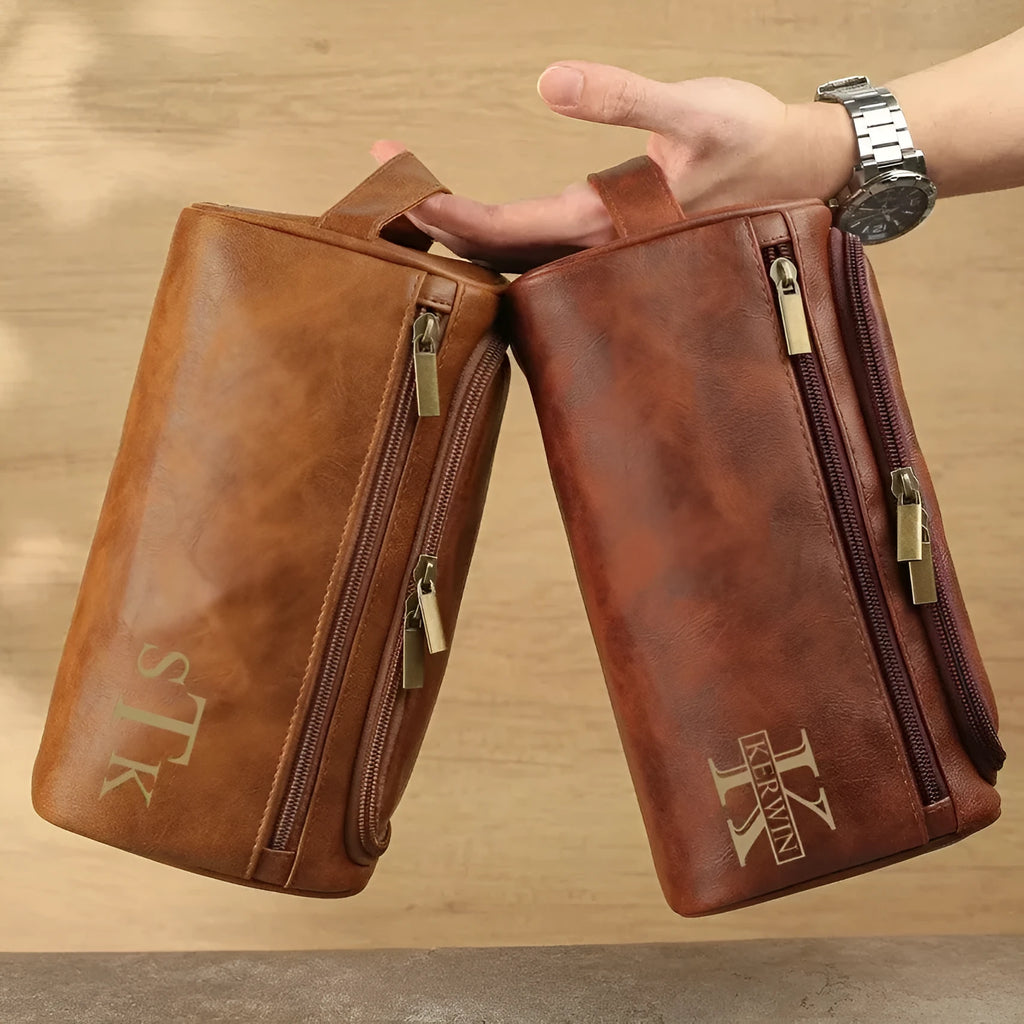 Men's neutral-coloured PU travel organiser with multiple compartments open showing interior layout