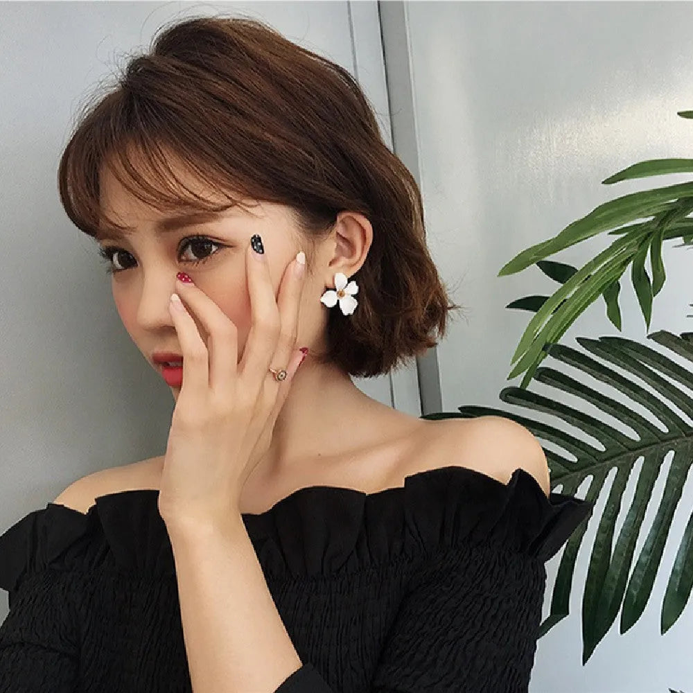 Flower stud earrings for women in white or pink with electroplated alloy construction
