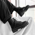 Black platform Dr. Martens boots with front zipper and frosted leather finish