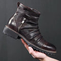 Men's black side-zip cowboy boots with embossed texture and a mid-height horseshoe rubber heel.