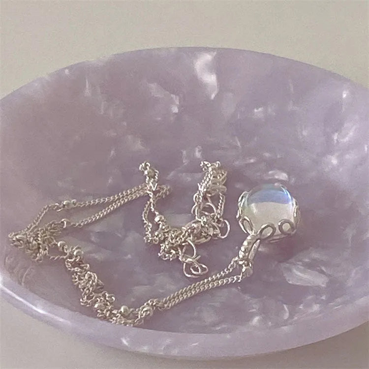 Women's silver ornamental stone necklace with geometric pendant on curb chain