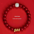 Handmade Chinese snake year bracelet with red cinnabar beads on a black cord.