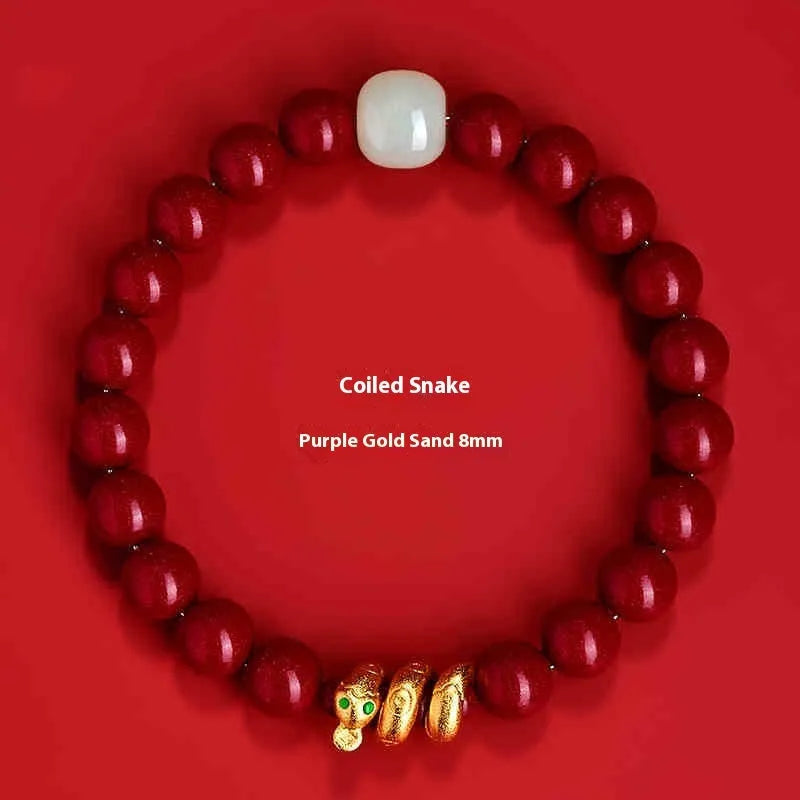 Handmade Chinese snake year bracelet with red cinnabar beads on a black cord.
