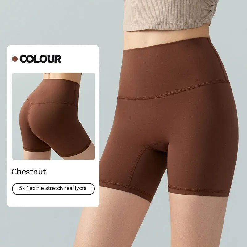 Women's high-waisted Lycra yoga shorts in leaf green, showing anti-exposure construction and short length.