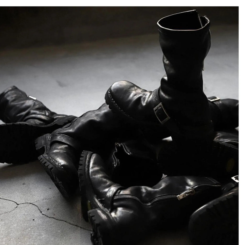 Men's dark retro Martin ankle boots with side zipper on a solid background.