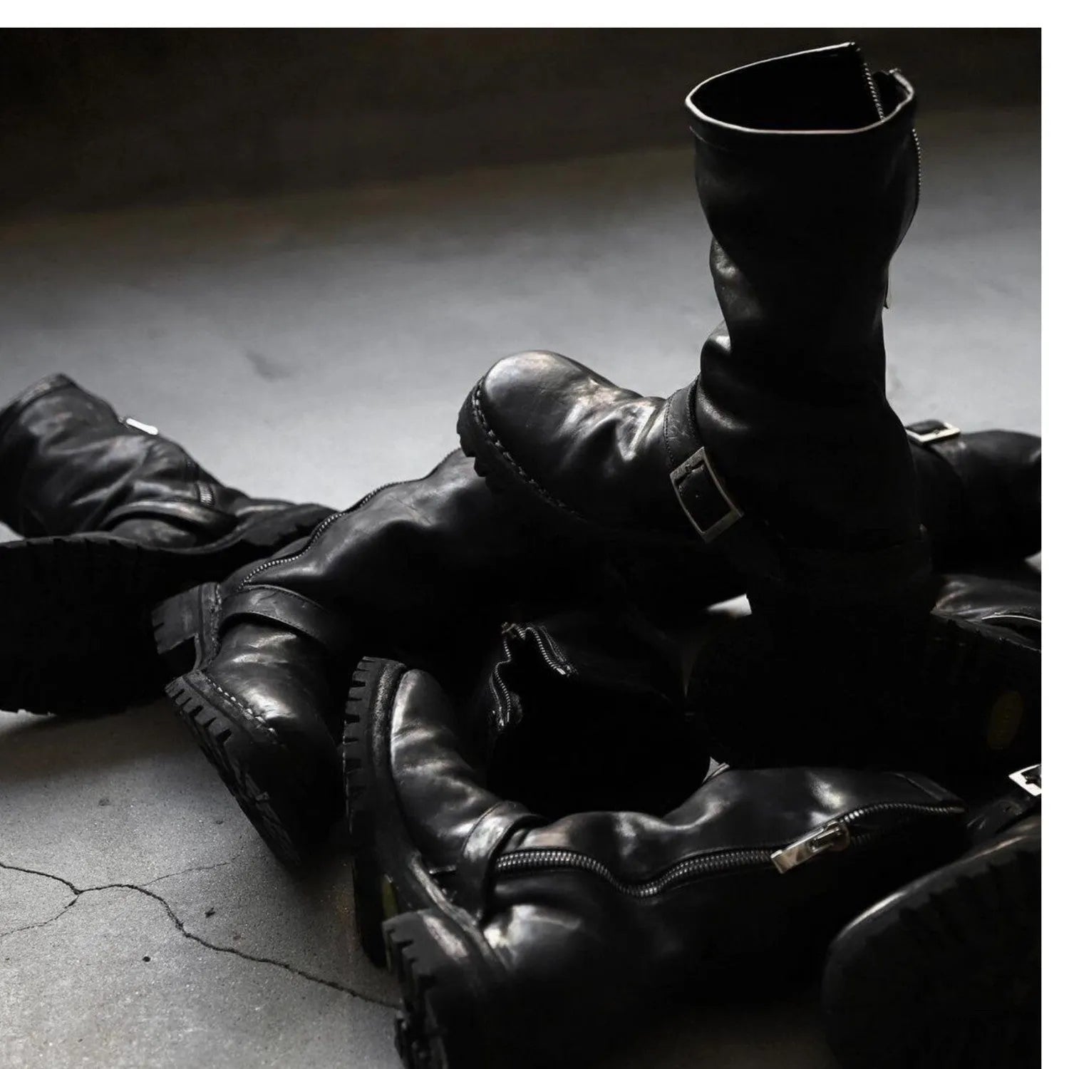Men's dark retro Martin ankle boots with side zipper on a solid background.