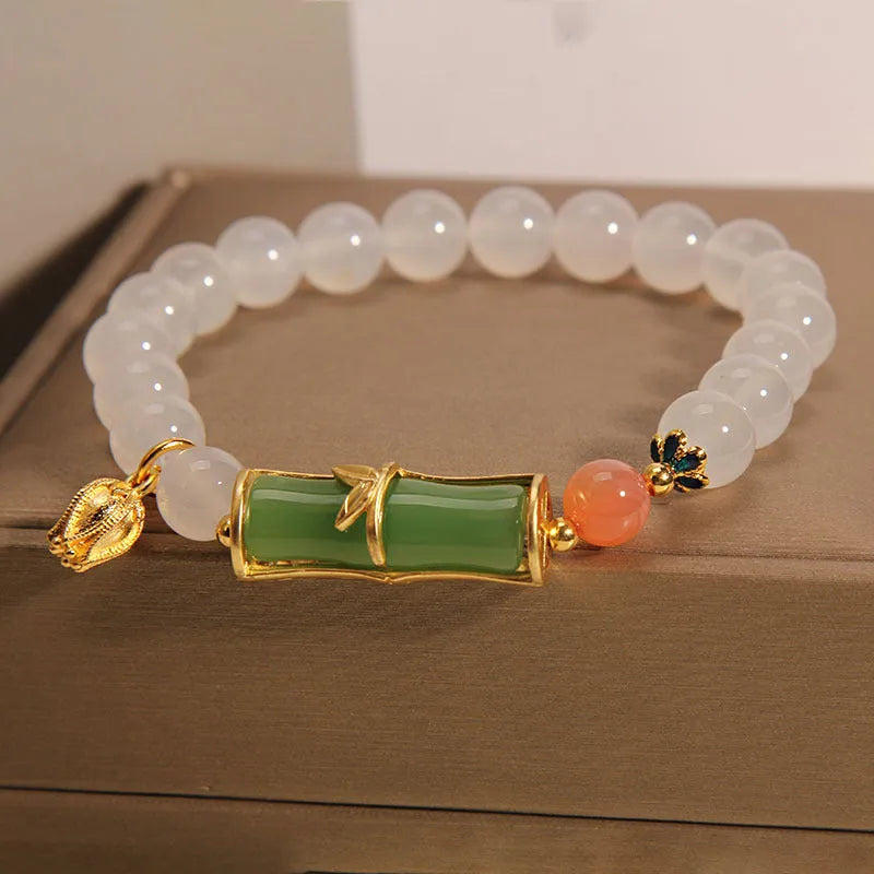 Women's natural style bracelet with jade beads, white agate centrepiece, and bamboo joint detailing.
