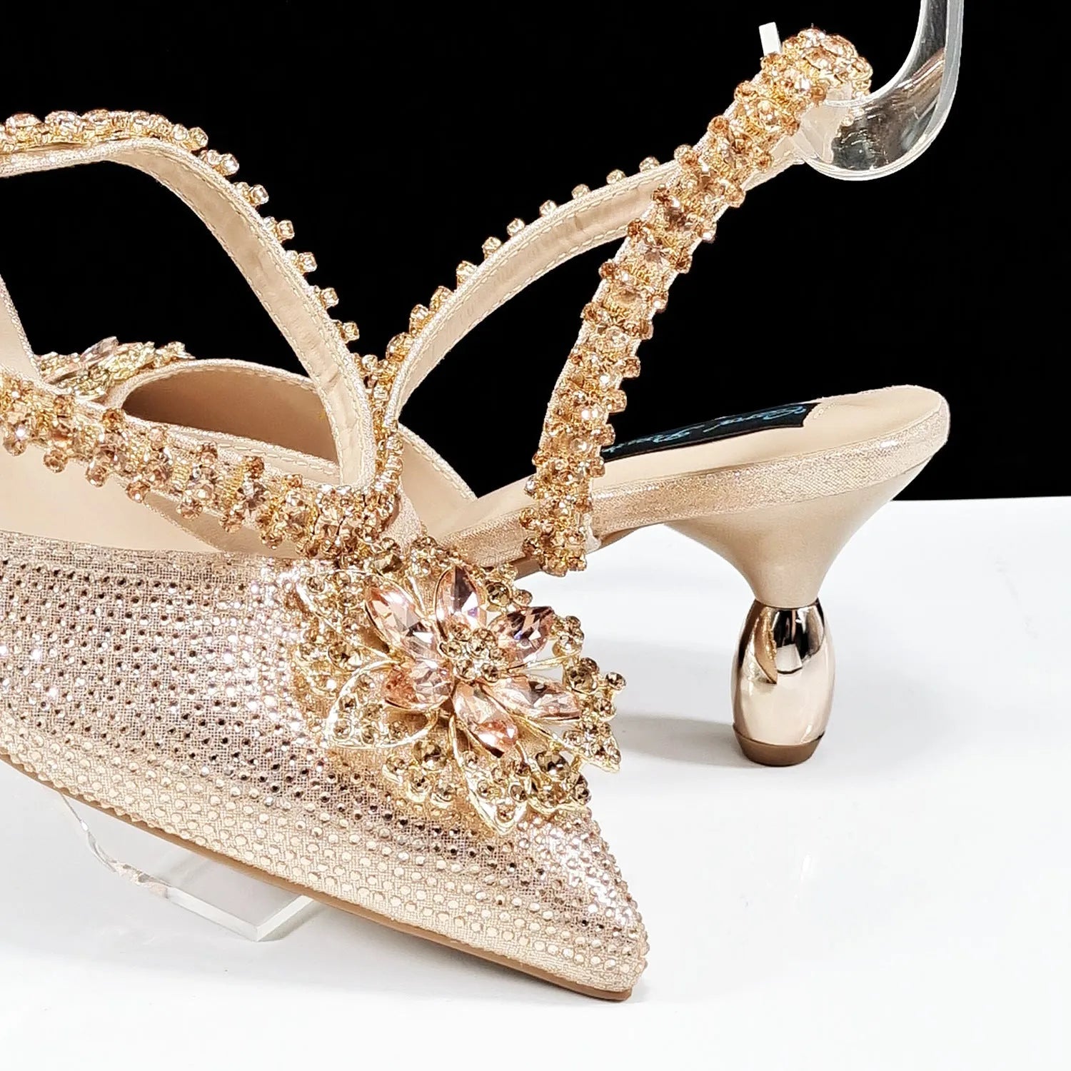 Women's black synthetic leather high-heel shoes with rhinestone ankle chain and matching hard clutch bag.