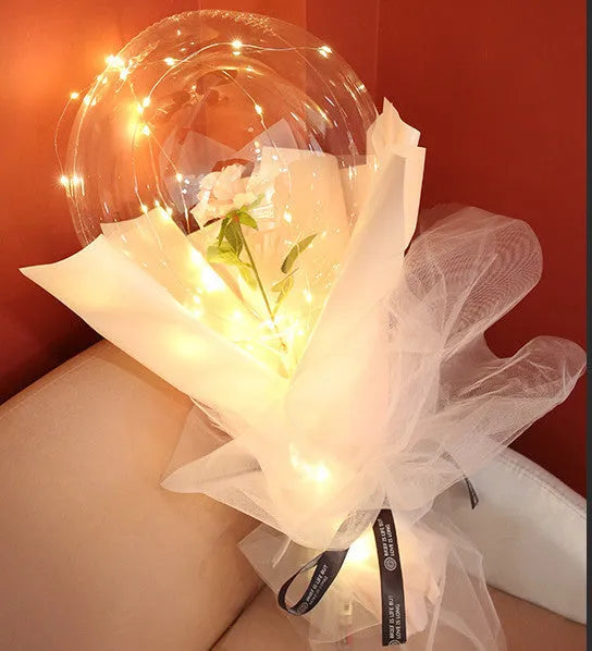 Transparent LED luminous balloon with artificial rose and built-in light, shown as a DIY bouquet kit.