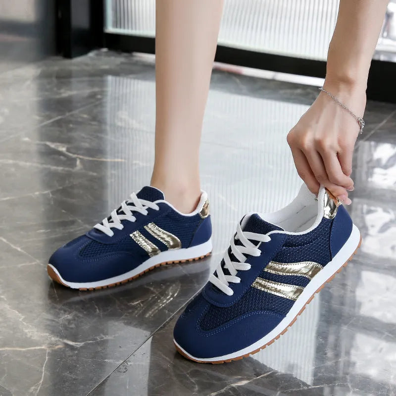 Blue women's tennis shoes with cross shoulder straps and lace-up front, artificial leather fabric uppers