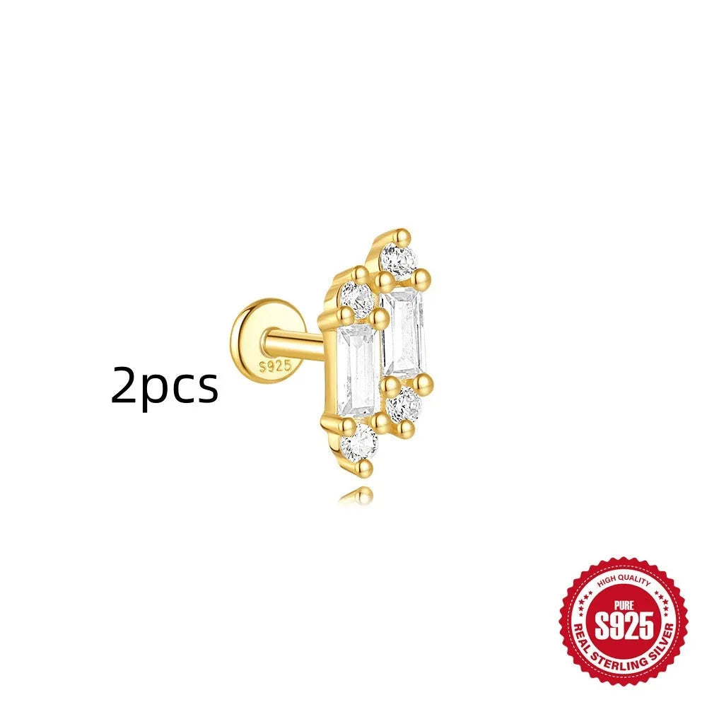 Geometric kite-shaped sterling silver earring with rhinestone head and gold chain tassel.