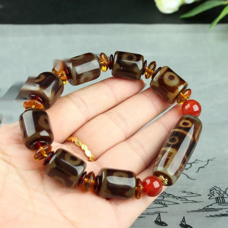 Agate Tibetan dzi bead bracelet with three-eye design and polished finish