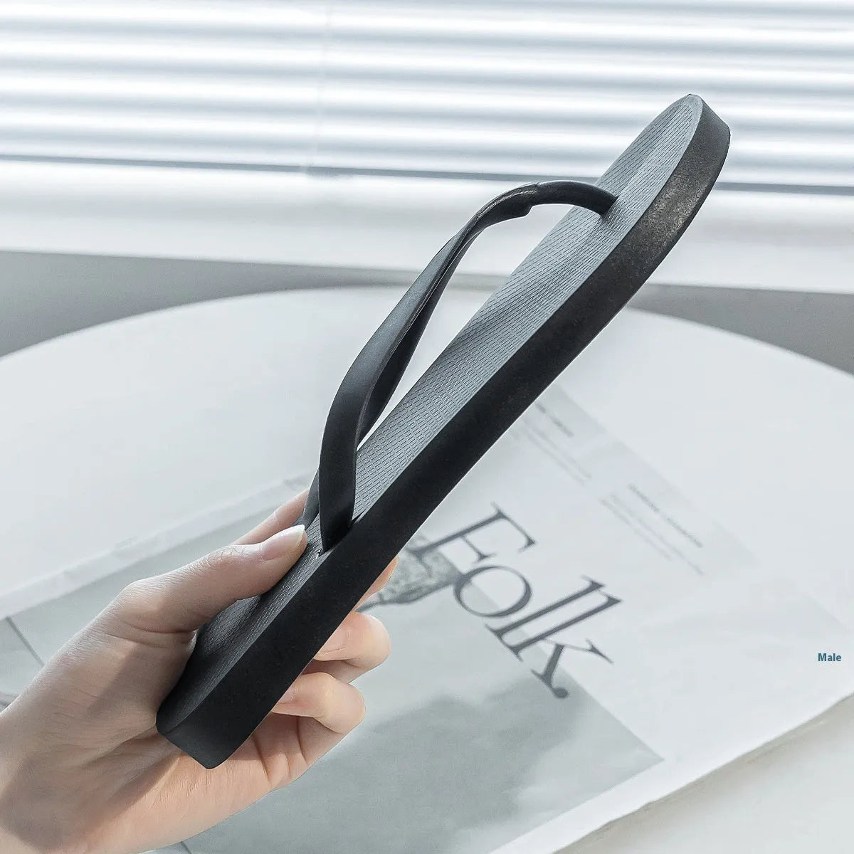 Foldable casual slippers with a hollow-out plastic upper and non-slip PVC sole in black colour.