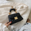 Purple rhombus-shaped small square shoulder bag with crossbody strap against neutral background