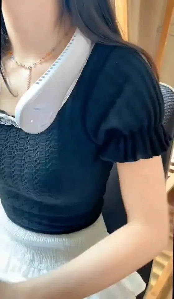 Pink bladeless neck fan being worn, showing soft neckband and compact fan unit.