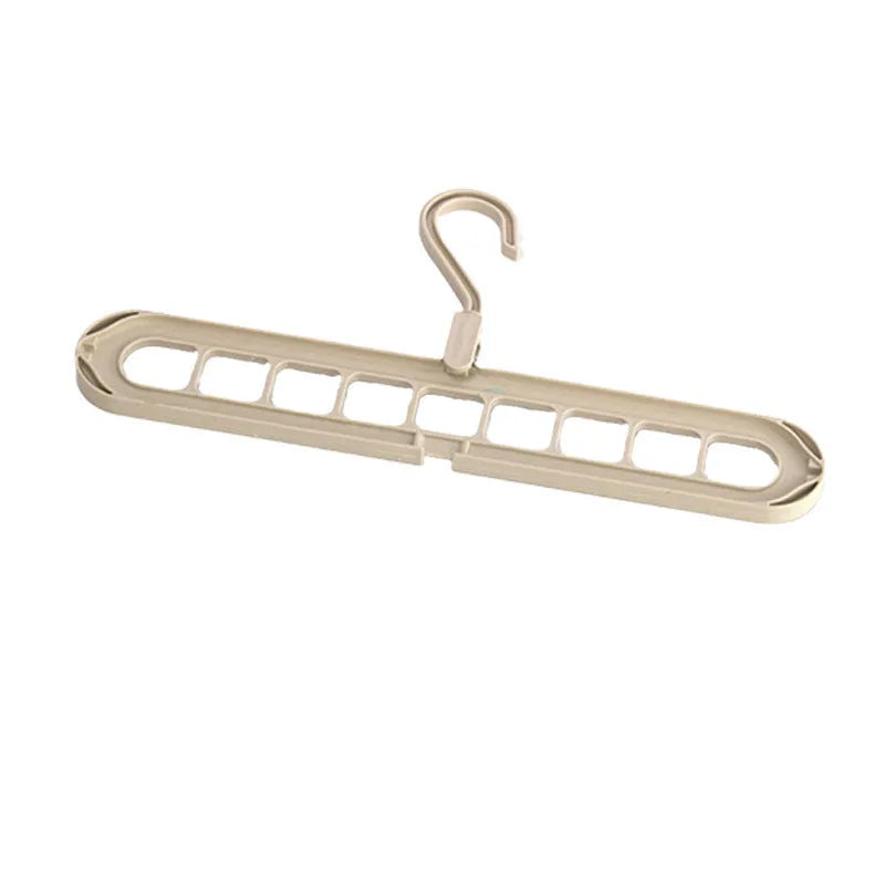 Green plastic nine-hole folding pant hanger for trousers and skirts.
