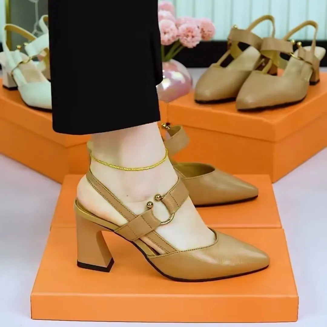 Women's apricot-coloured leather sandals with a closed toe, backless design, chunky heel, and an oversleeve strap.