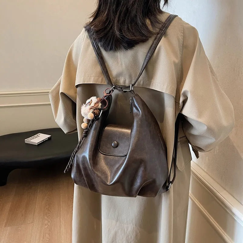 Large capacity PU leather commuter backpack with single shoulder strap in horizontal square design