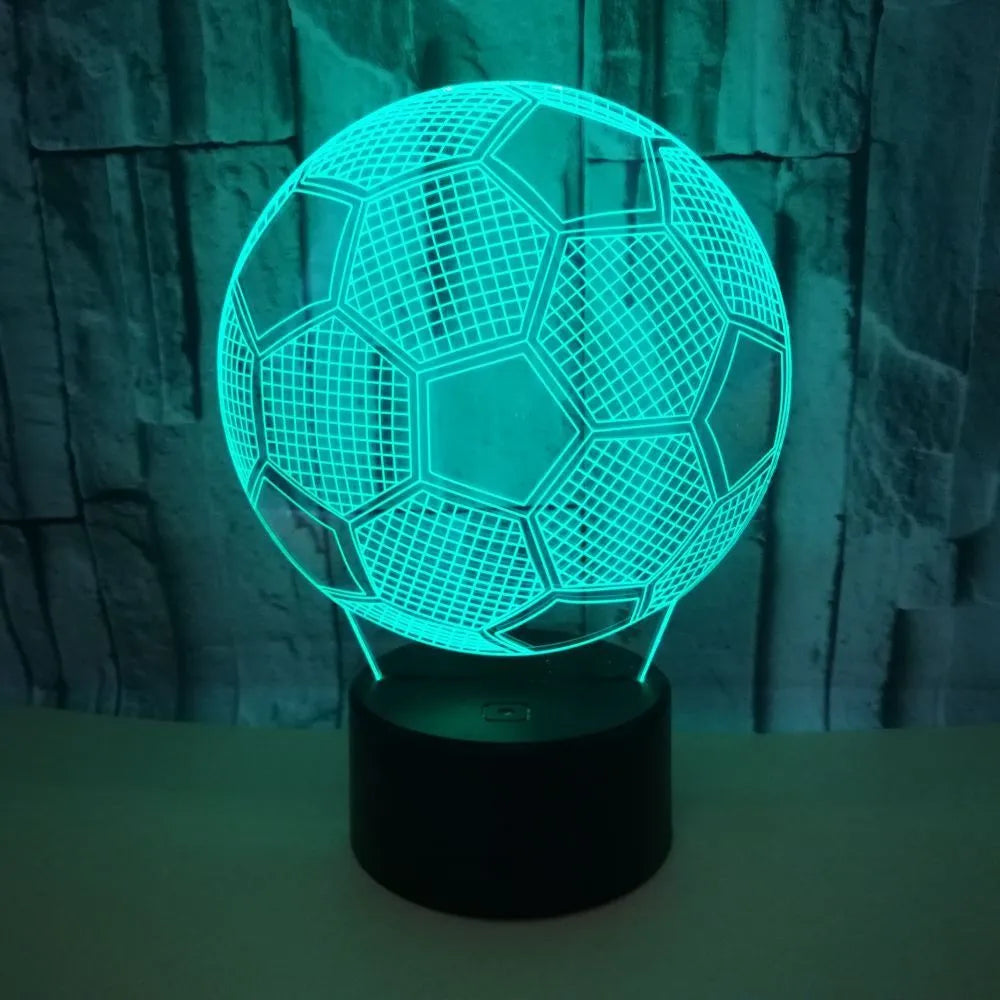 3D football-shaped LED night light showing colour gradient on acrylic panel with touch control base.