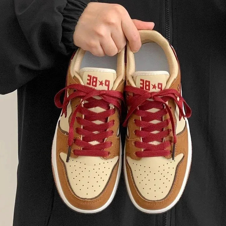 Brown women's lace-up platform sneakers with sequin details and a rubber sole.