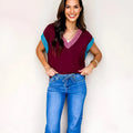 Burgundy loose-fitting V-neck sweater with contrast trim and cuffed short sleeves