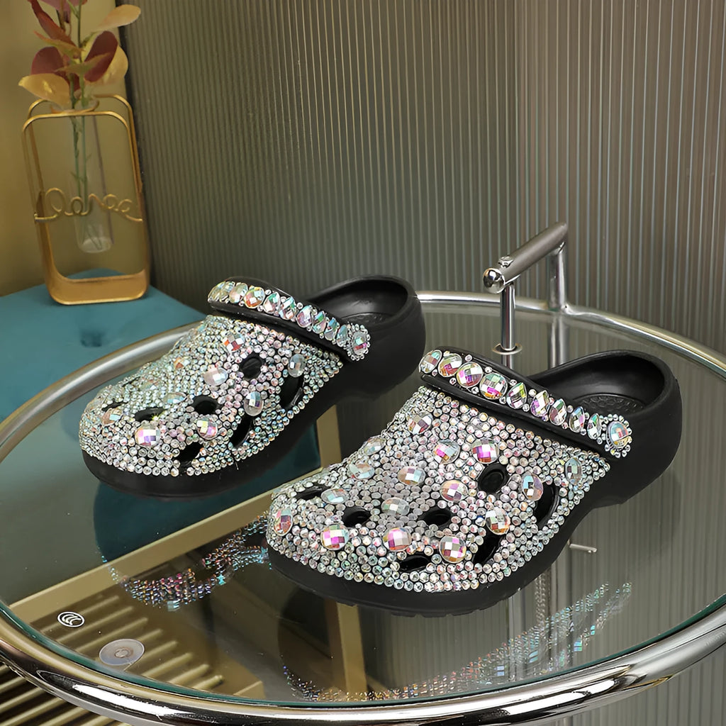Black women's platform sandals with rhinestones around holes and a textured EVA sole.