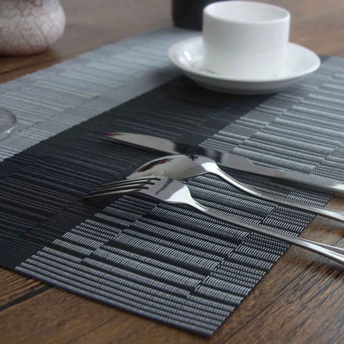 Modern PVC kitchen sink mat in a gradient bamboo colour on a countertop, showing its non-slip texture and size.