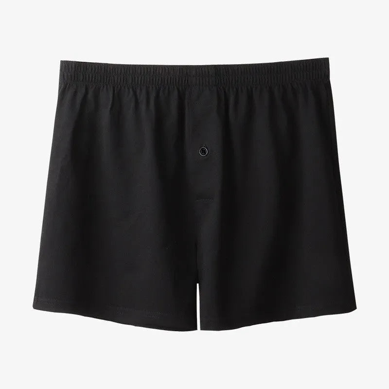 Men's solid-colour cotton boxer shorts with a high-waist, loose fit on a neutral background.
