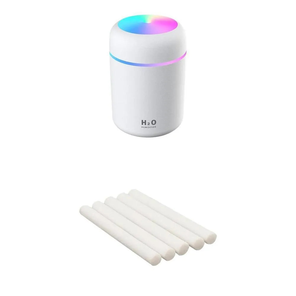 Pink USB portable humidifier with 300ml water tank on wooden desk surface