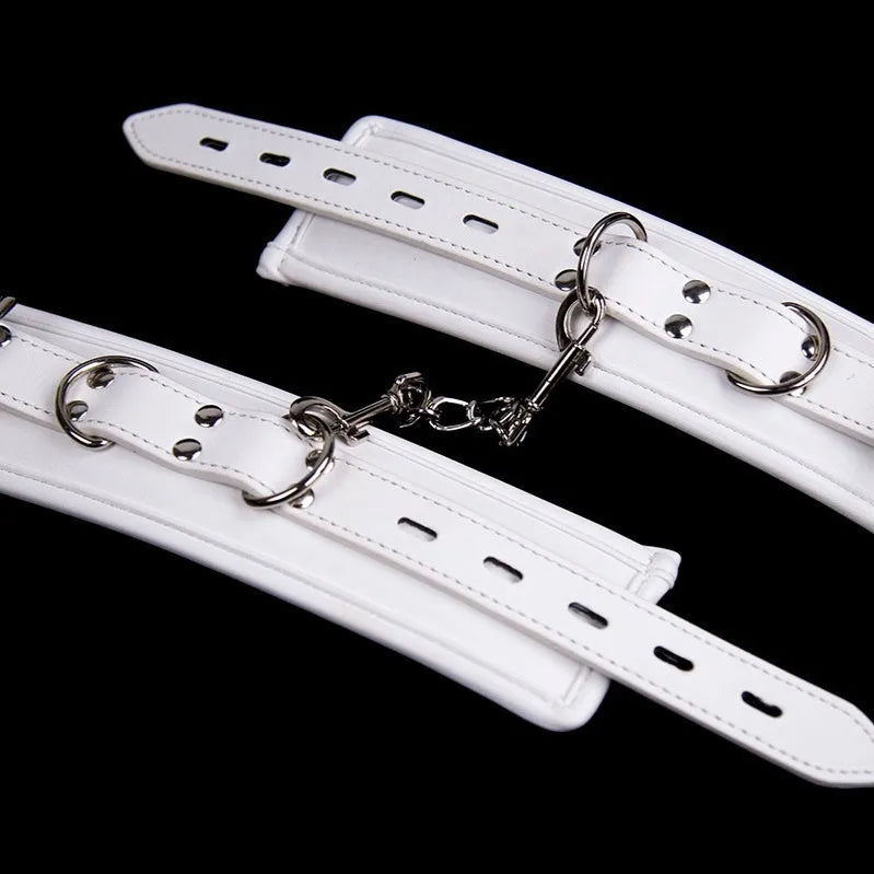 White PU sponge bondage restraint set showing handcuffs, foot cuffs, and neck scarf