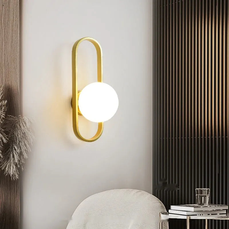 Minimalist wall lamp with glass shade and iron body in black or gold finish showing 12W tri-colour light source
