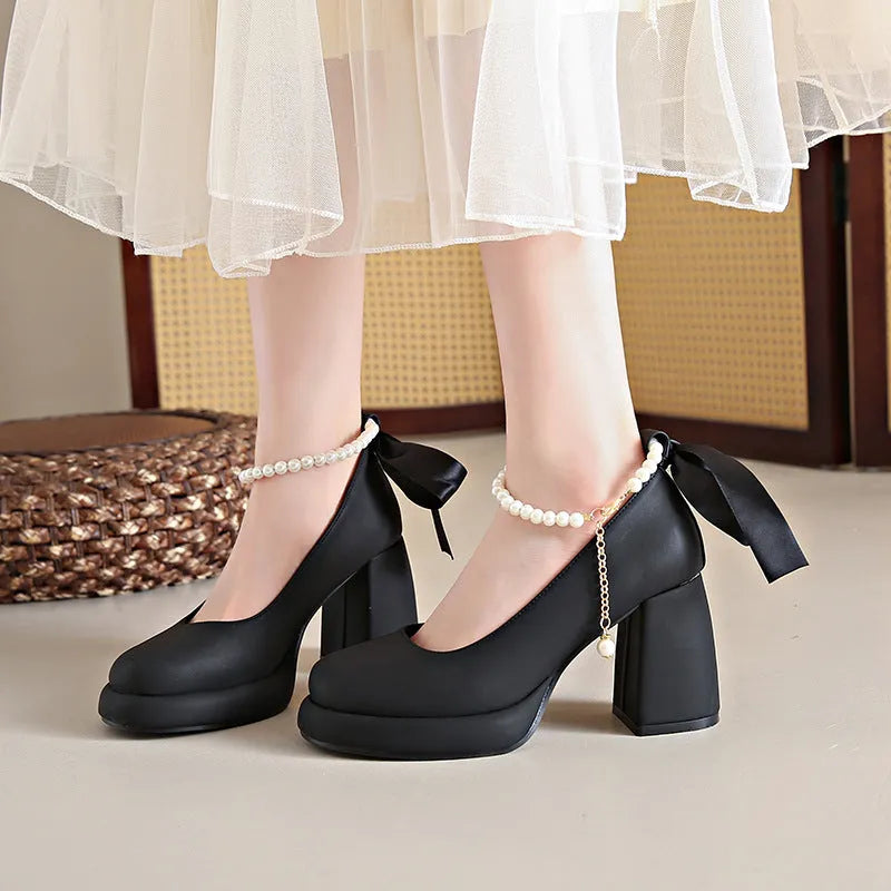 Women's beige Mary Jane shoes with chunky heel and ankle-strap buckle on a white background