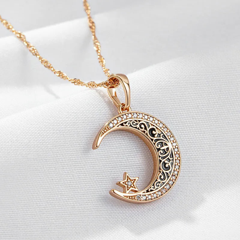 Rose gold-tone moon and star pendant necklace with enamel details on a water wave chain.