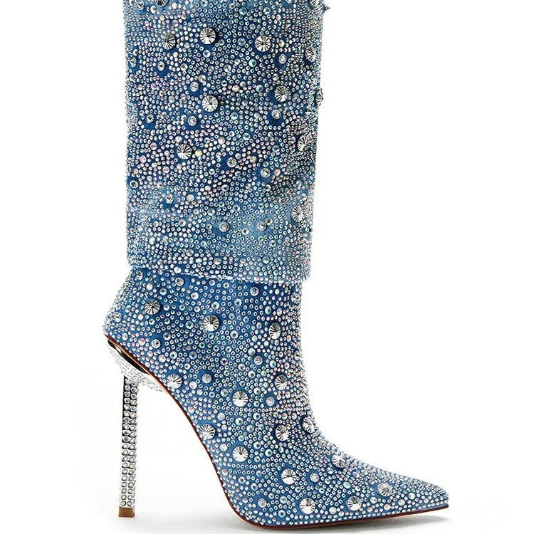 Women's blue denim pointed toe heel boots with stretchy fit on a plain background