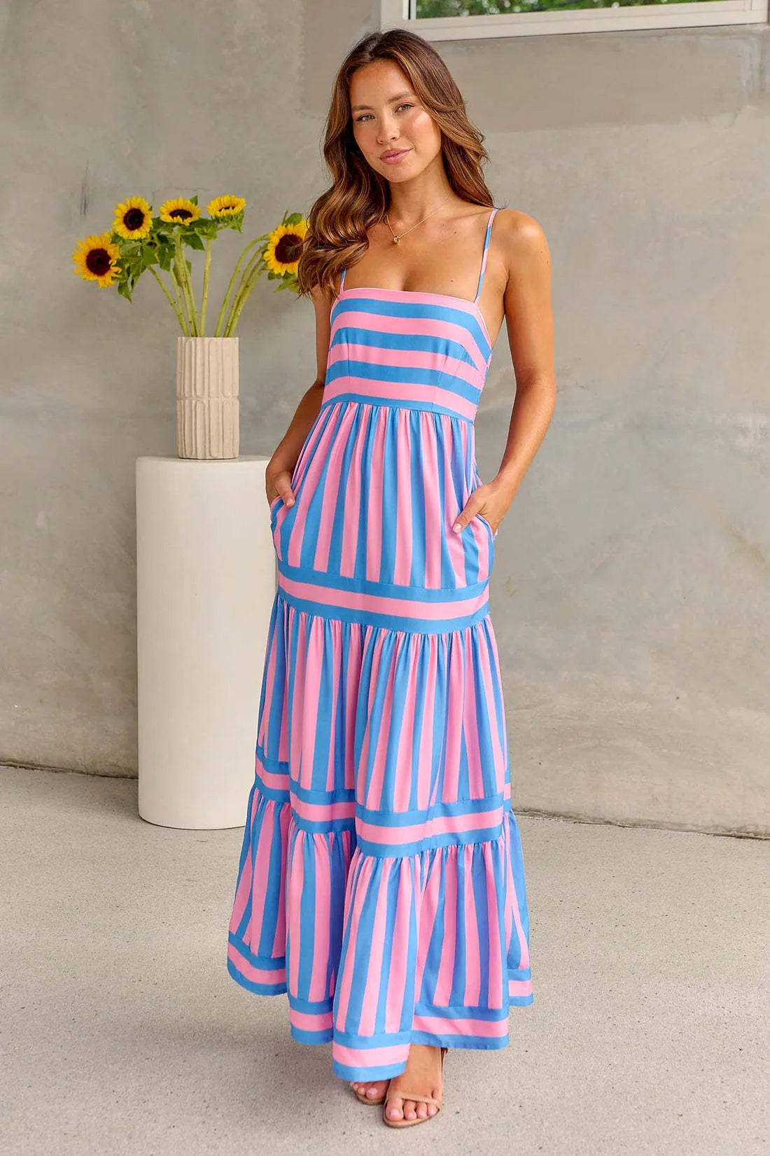 Women's long striped summer dress with suspenders, a square neckline, backless design, and side pockets.