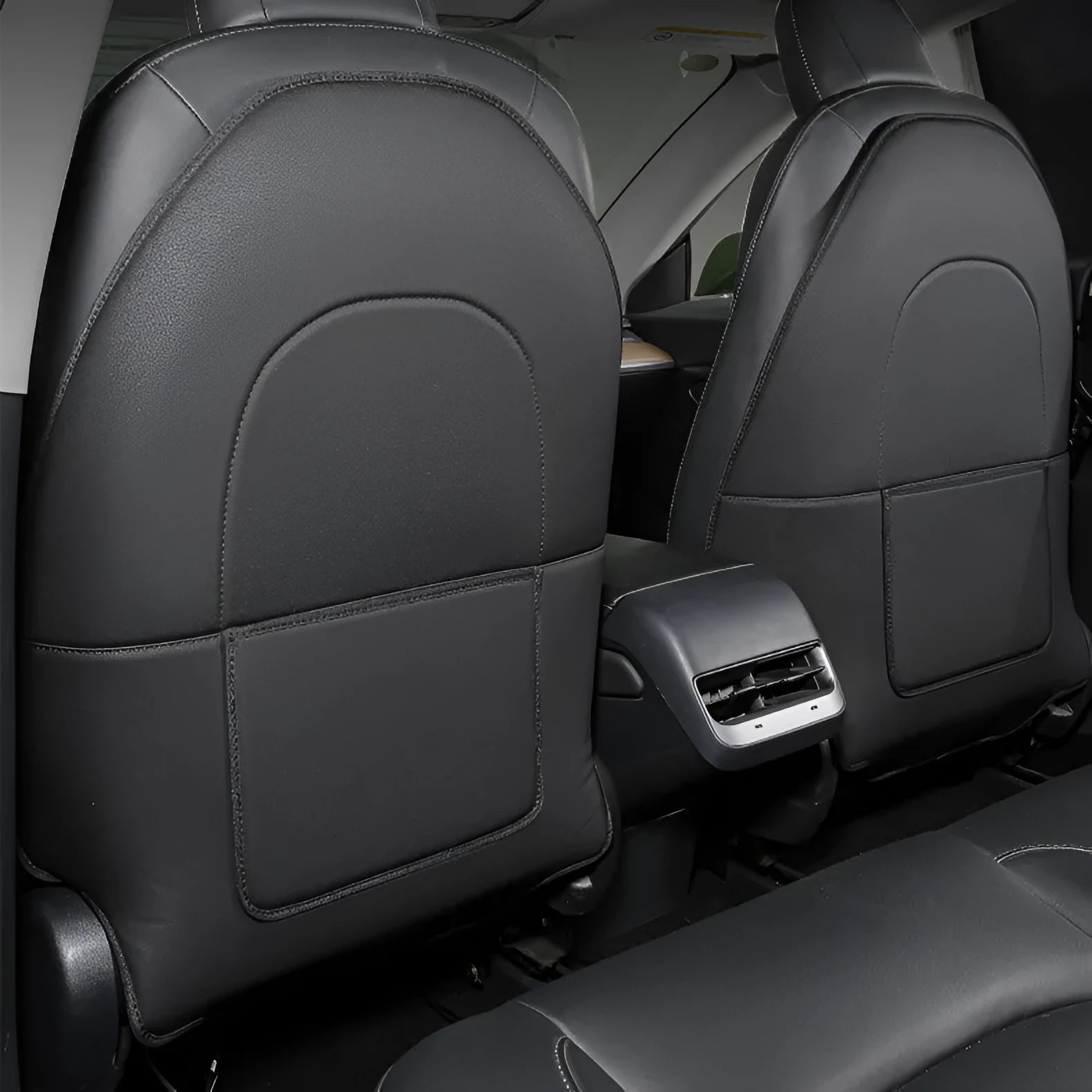 Set of two black leather anti kick pads for car rear seats, shown with dimensions.
