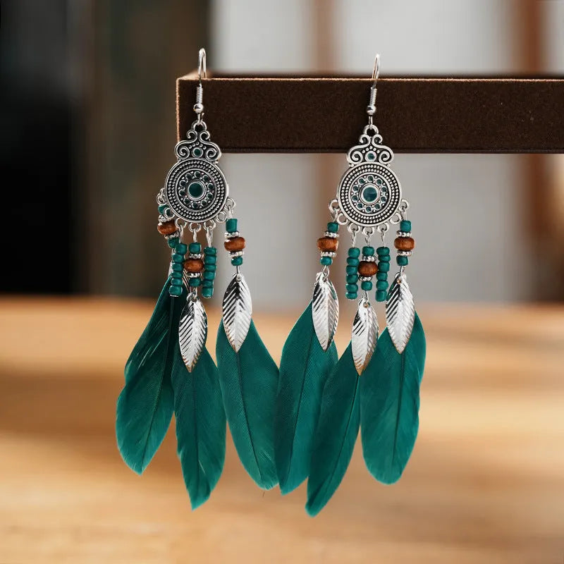 A pair of round drop feather earrings in alloy with Bohemian patterning, shown in one of 14 available colours.