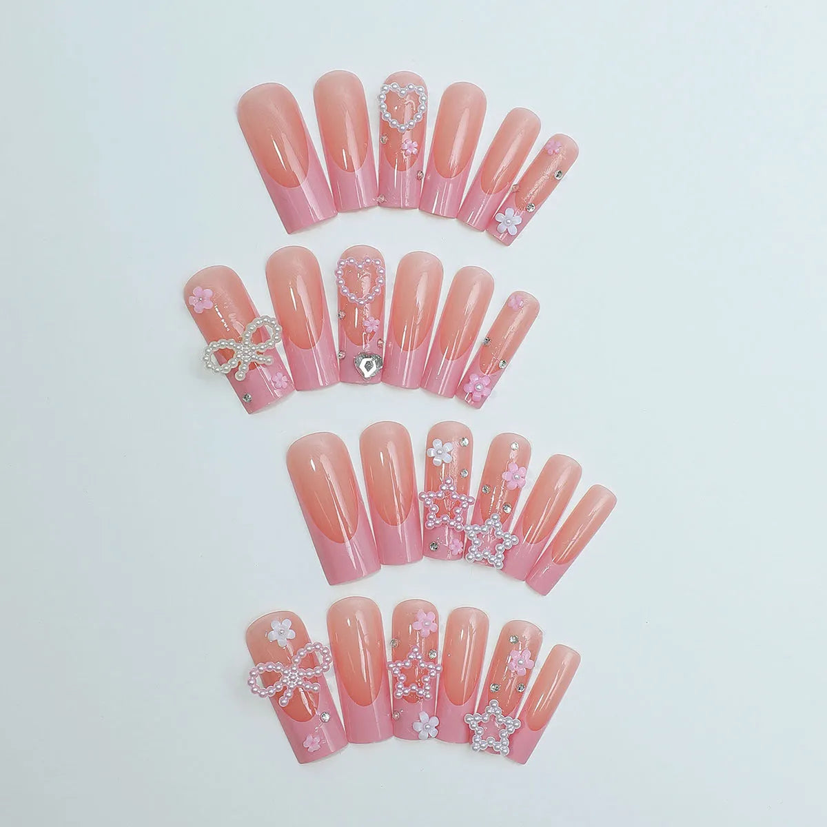 Super long artificial nails with French spot drill, a bow, and a love pattern in colour XB-70-48.