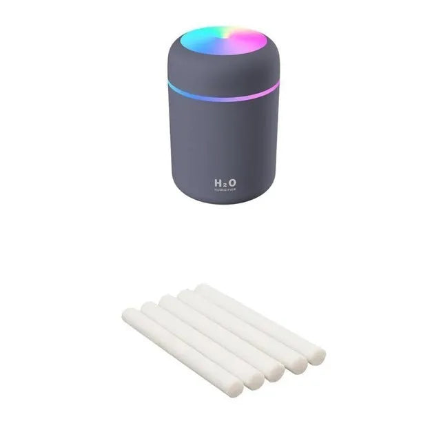 Pink USB portable humidifier with 300ml water tank on wooden desk surface