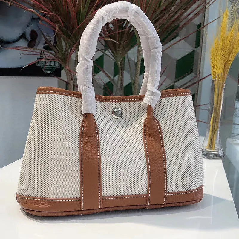 Women's canvas crossbody shoulder tote bag with leather detailing and bucket shape