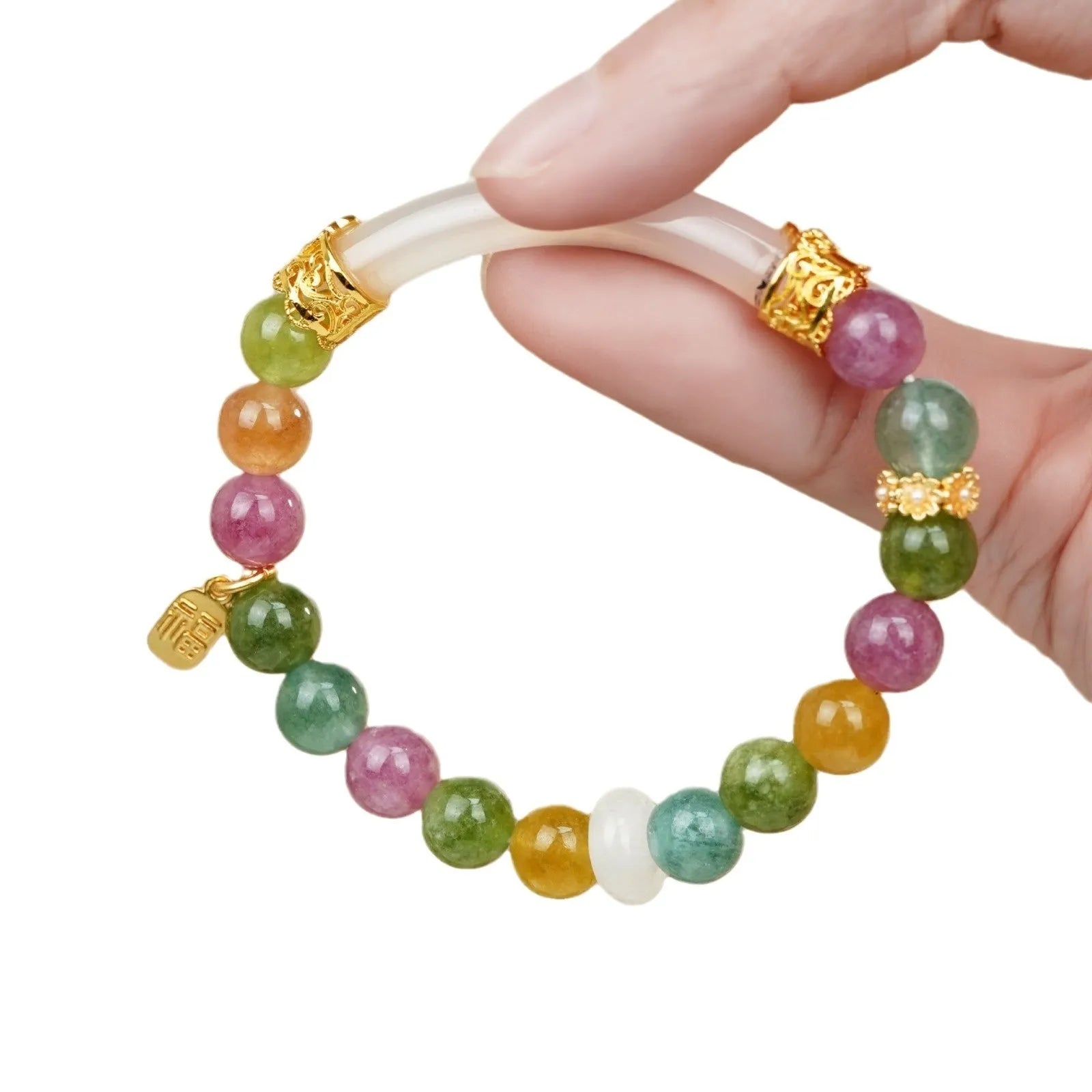Rainbow coloured electroplated tourmaline half bracelet for women on a wrist.