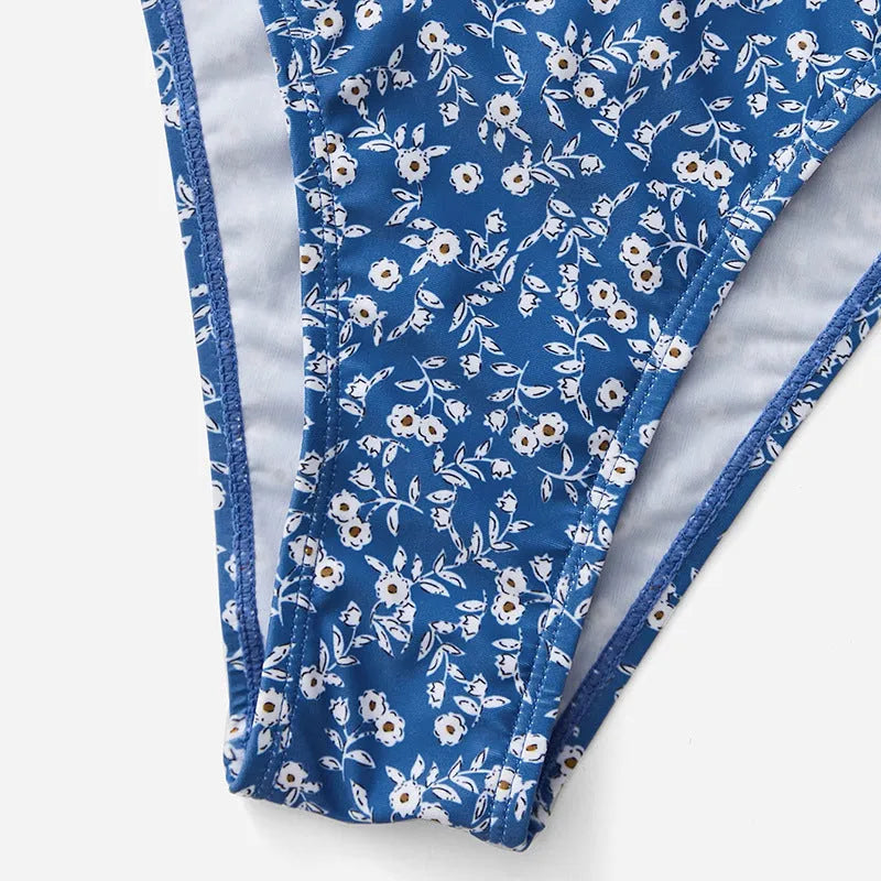 Blue three-piece swimsuit set consisting of a top and shorts, made from polyester fabric.