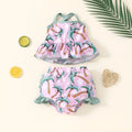 White two-piece girls swimsuit set with short sleeve top and shorts on a hanger
