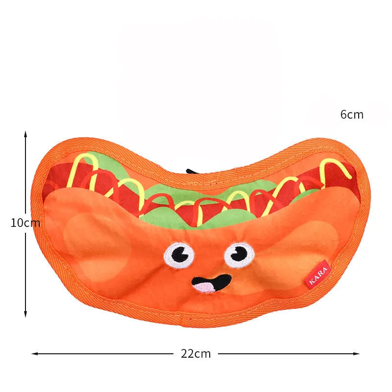 Hamburger-shaped dog chew toy with red, yellow and brown colours showing crinkle and squeak features
