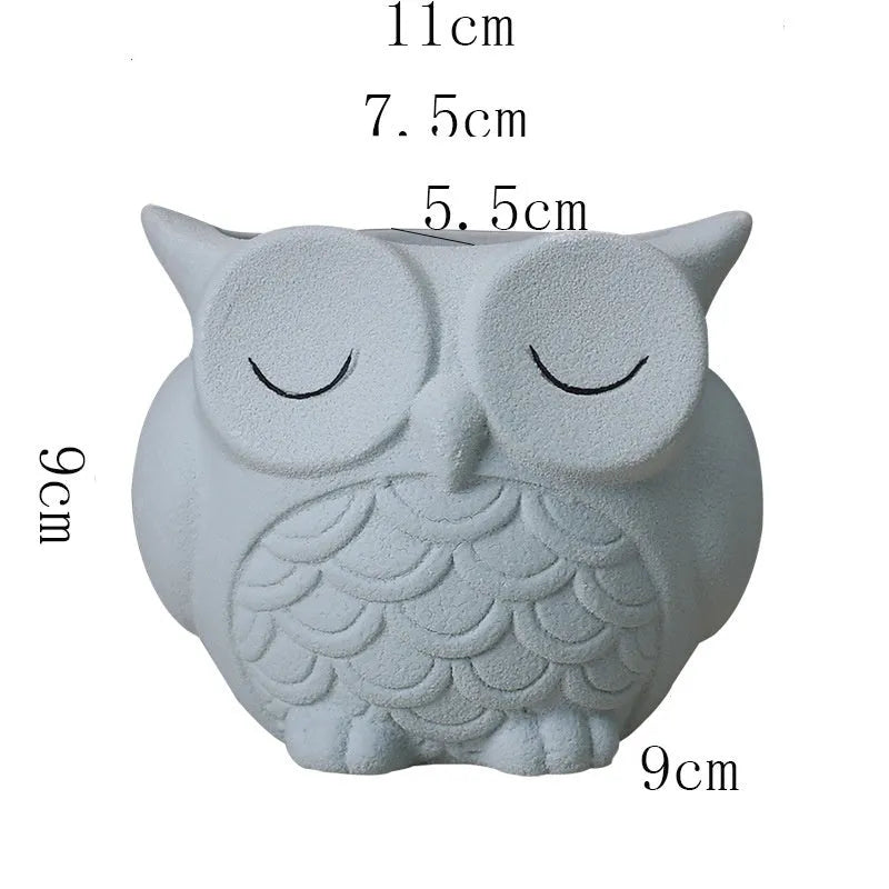 Handmade frosted ceramic flower pot with cartoon owl design, shown in light pink colour.