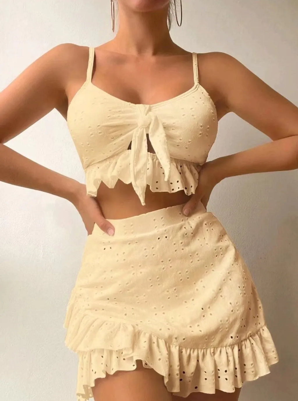 Women's solid colour three-piece skirt bikini swimsuit in polyester fabric.