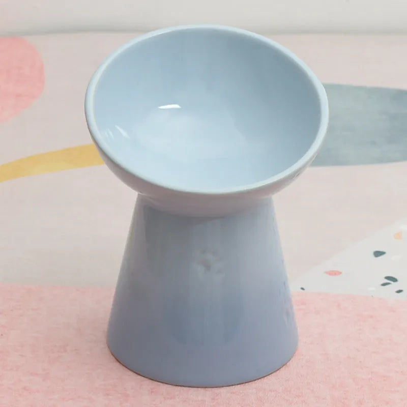 A white ceramic pet bowl with a high foot and raised neck protector to prevent tipping.