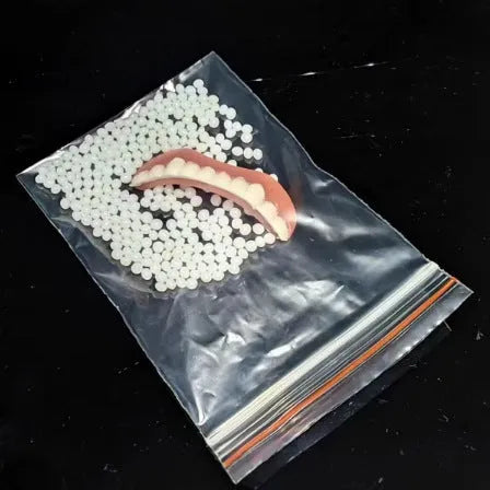 Silicone simulation dentures set showing upper and lower artificial teeth for dental training