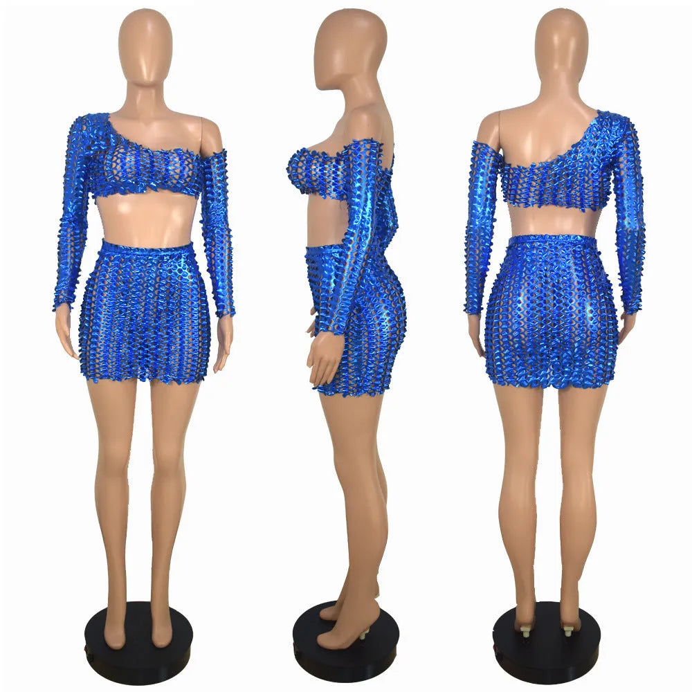 Women's black two-piece dress set with sleeveless top, short skirt, and hollow-out net detailing.